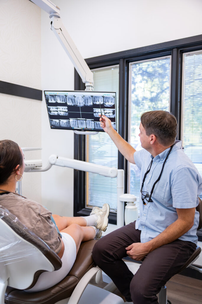 Dr. Joel Horton pointing to digital X-rays on the screen