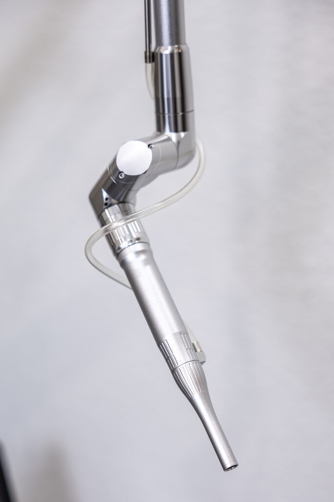Dental handpiece on an articulated arm